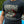 Load image into Gallery viewer, Man wearing a Bonneville Salt Flats black graphic t shirt standing in front of a race car
