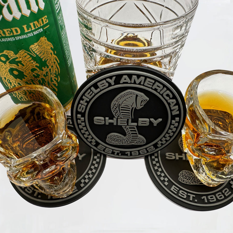 Shelby Cobra coaster among several cocktail glasses