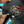 Load image into Gallery viewer, Man wearing a Ride It Like You Stole It black graphic shirt by Wicked Quick while looking at a muscle car
