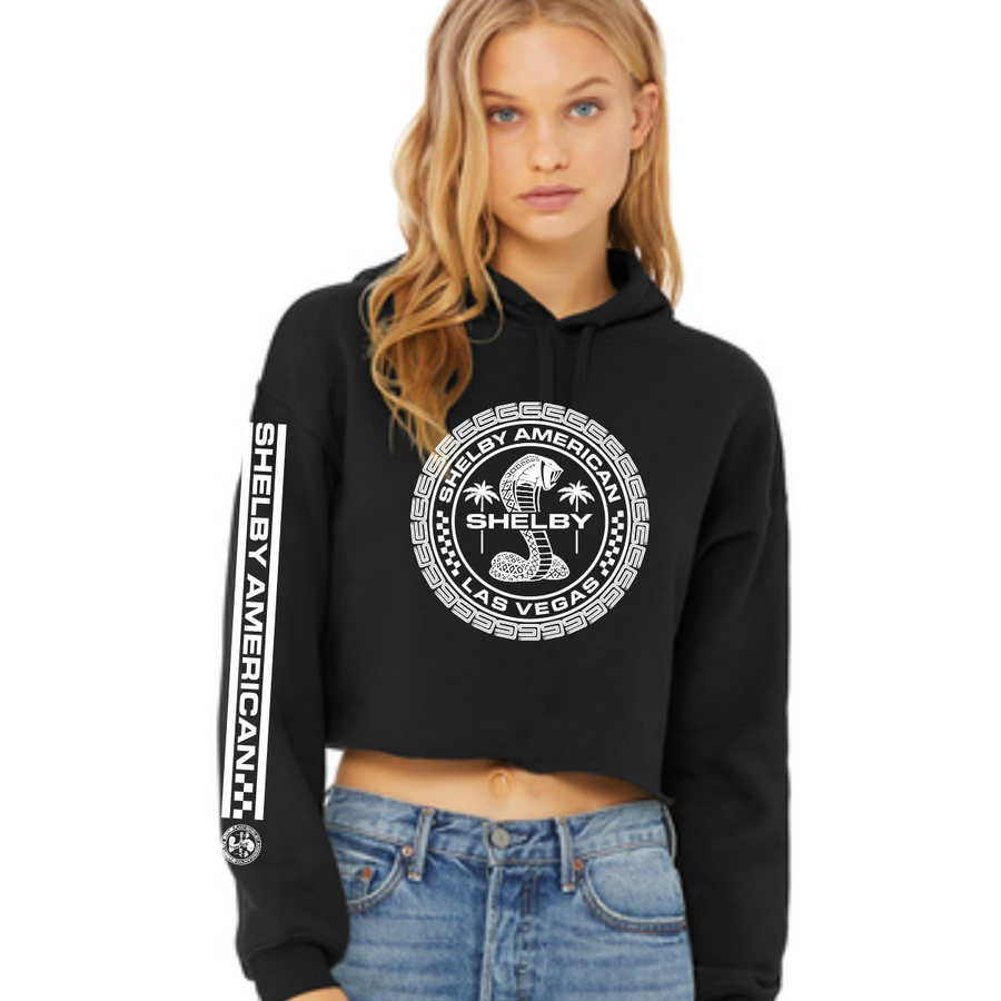 Woman modeling a cropped black hoodie with white Shelby Cobra graphics