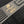 Load image into Gallery viewer, Close up of a Gold Shelby Cobra logo on a black graphic shirt
